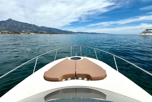 Boat on the water with mountains and another boat in the distance