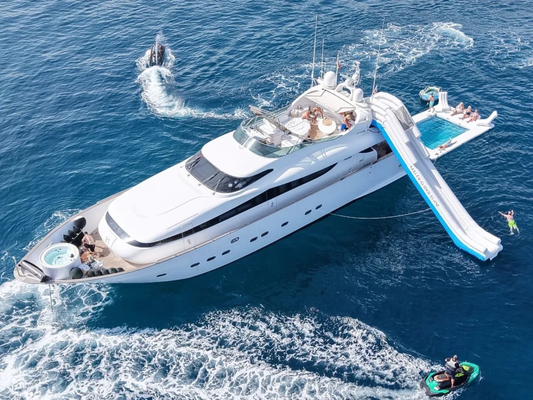 Luxury yacht with inflatable water slide in the ocean