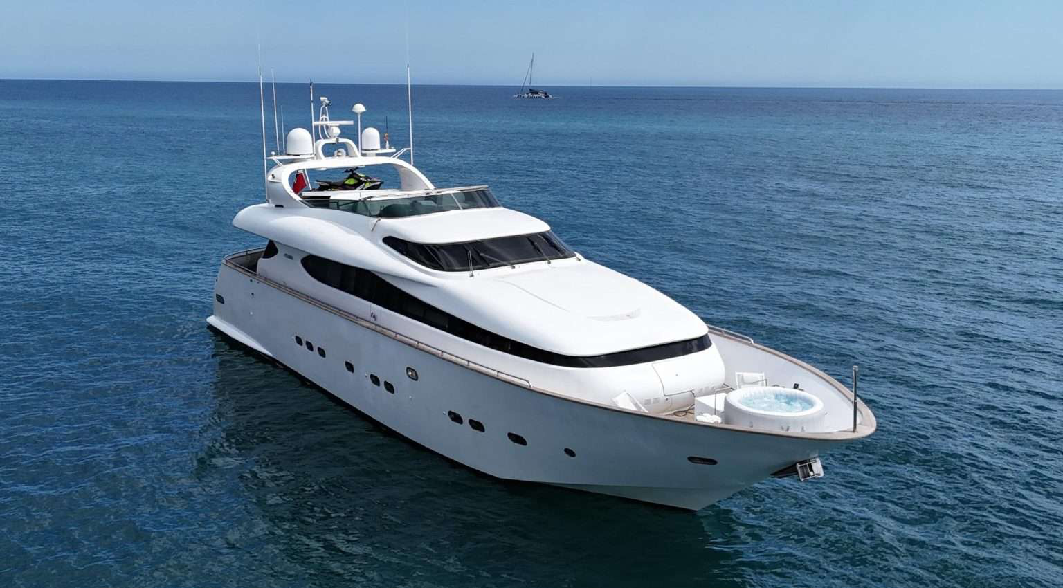 White yacht on the ocean with clear blue sky