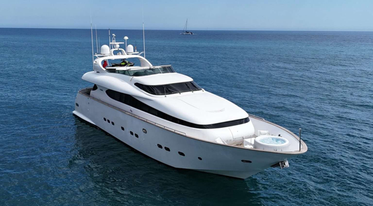 White yacht on the ocean with clear blue sky