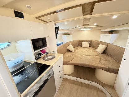 Interior view of MOA Platinum 32 yacht with lounge area and kitchenette